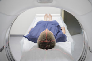 Patient receiving a CAT scan in hospital PET scan equipment. Medical scan of patient.